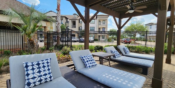 Patio with outdoor seating at Grand Villas at Tuscan Lakes luxury apartments