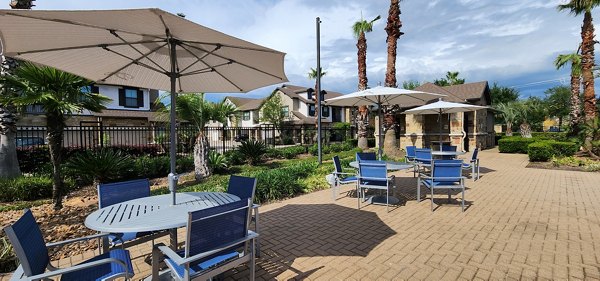 Outdoor patio with modern seating at Grand Villas at Tuscan Lakes Apartments