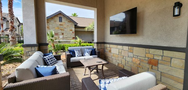 Charming patio with outdoor seating at Grand Villas at Tuscan Lakes Apartments, ideal for relaxation and entertaining in a luxury setting