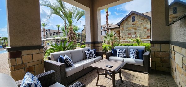 Elegant patio with stylish furniture at Grand Villas at Tuscan Lakes Apartments, perfect for relaxation and outdoor gatherings