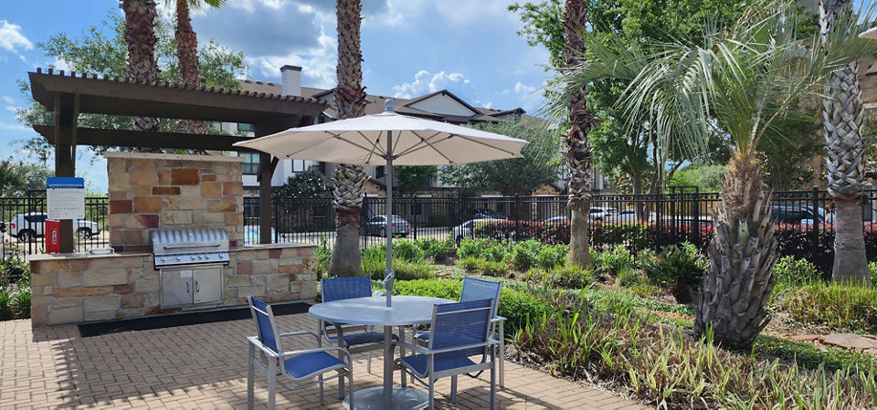 Outdoor amenities featuring grilling stations at Grand Villas at Tuscan Lakes Apartments, perfect for gatherings in the open air