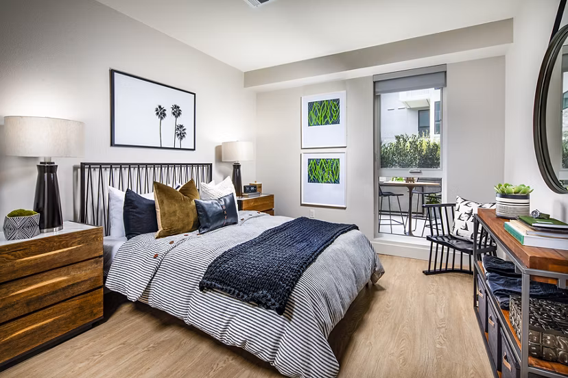 Cozy bedroom featuring plush bedding and modern decor at Llewellyn Apartments