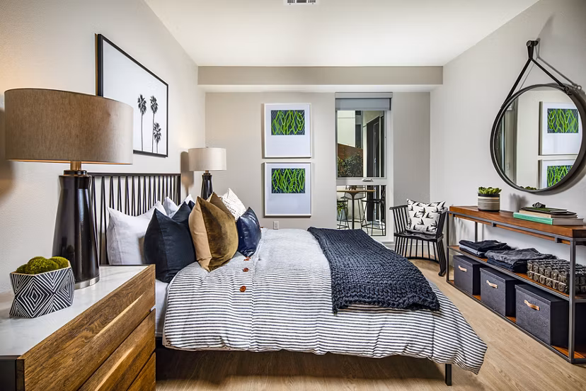 Cozy bedroom with modern decor at Llewellyn Apartments: luxury Greystar property showcasing sophisticated interiors