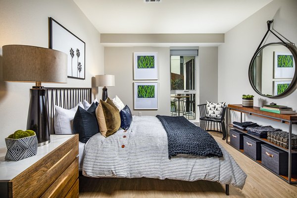 Cozy bedroom with modern decor at Llewellyn Apartments: luxury Greystar property showcasing sophisticated interiors