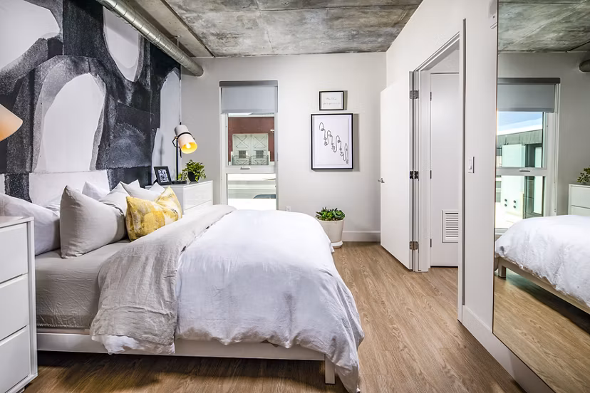 Cozy bedroom with contemporary decor and ample natural light at Llewellyn Apartments luxury apartments