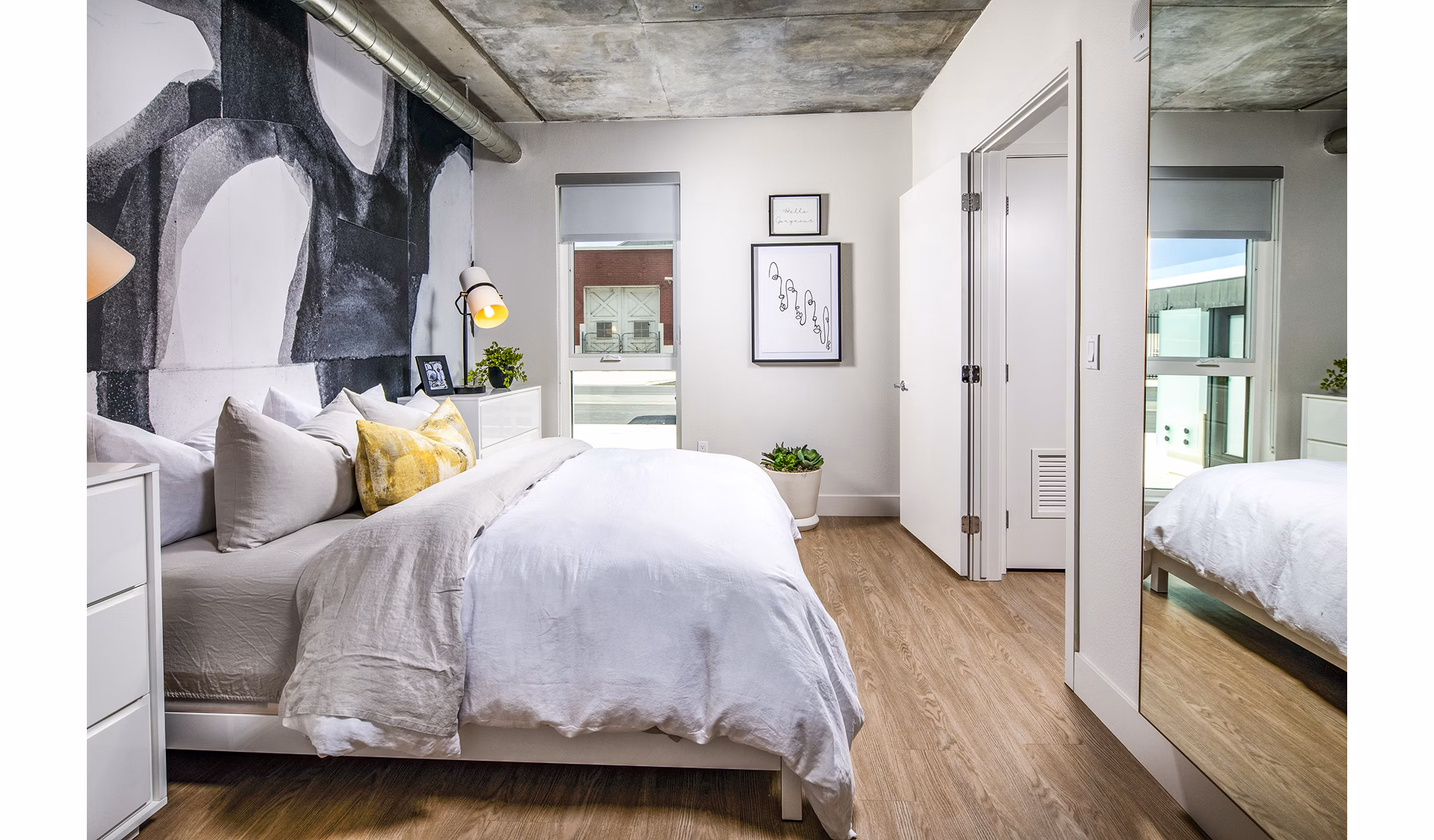 Cozy bedroom with contemporary decor and ample natural light at Llewellyn Apartments luxury apartments
