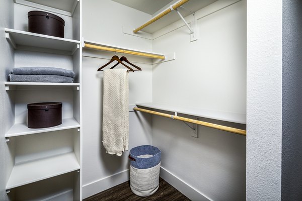 Cozy bedroom with modern decor at Llewellyn Apartments, offering luxury living in a serene neighborhood