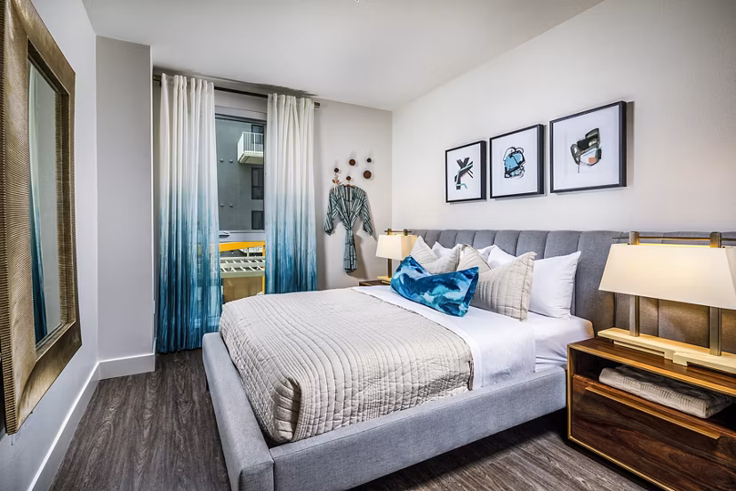 Luxury bedroom with modern decor at Llewellyn Apartments, featuring spacious layout and stylish furnishings for a comfortable living experience