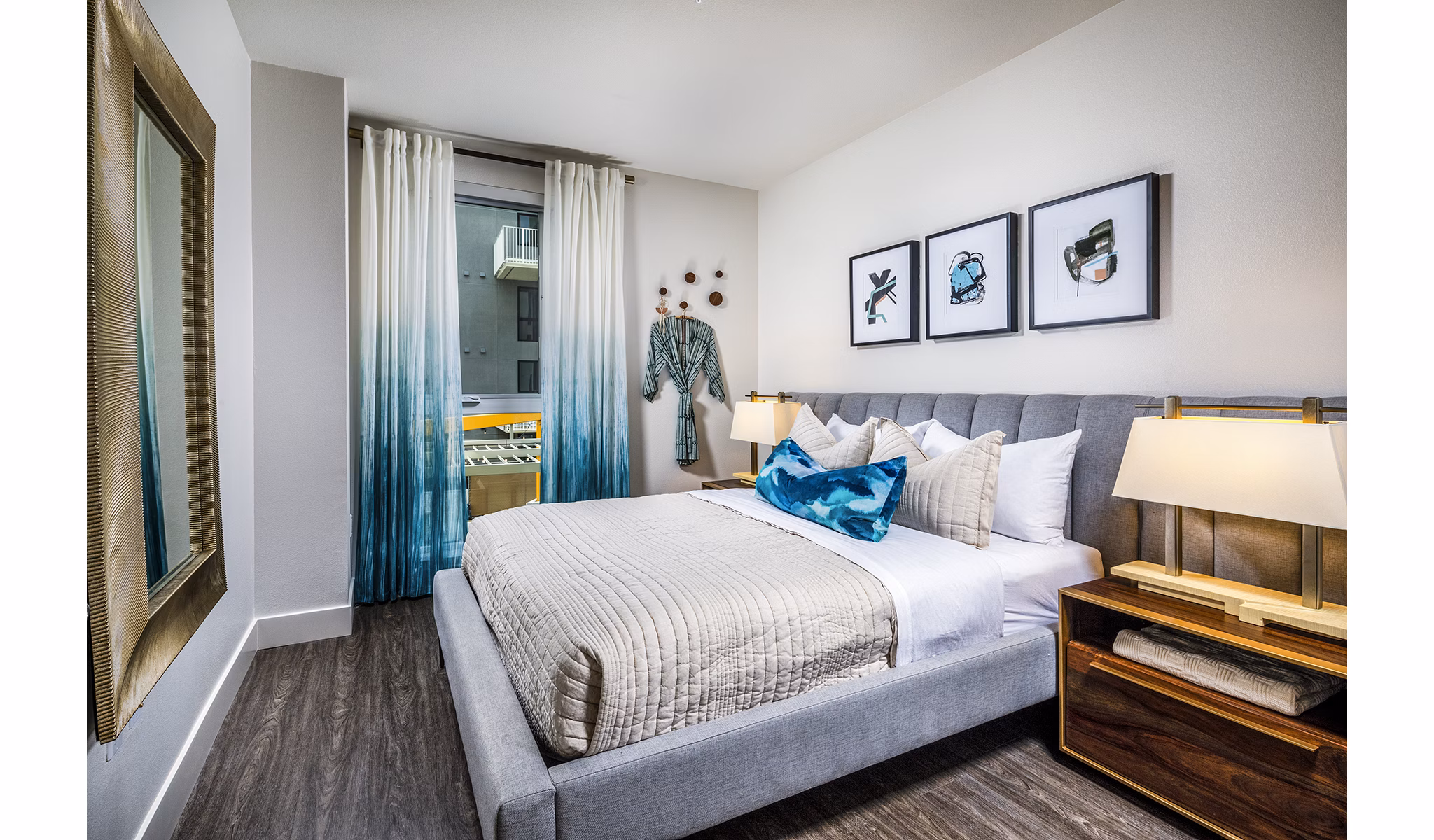 Luxury bedroom with modern decor at Llewellyn Apartments, featuring spacious layout and stylish furnishings for a comfortable living experience