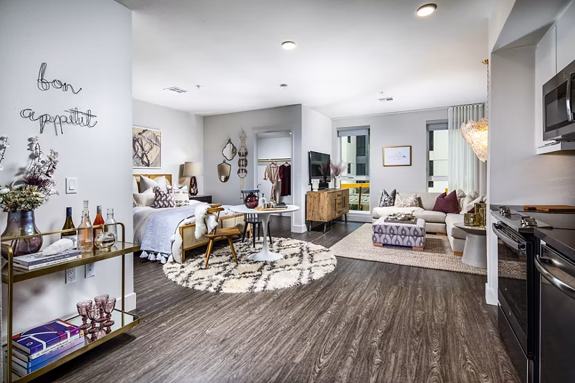 Cozy bedroom featuring modern decor and natural light at Llewellyn Apartments, a luxury property by Greystar in a prime location