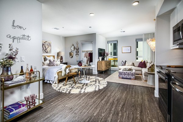 Cozy bedroom featuring modern decor and natural light at Llewellyn Apartments, a luxury property by Greystar in a prime location