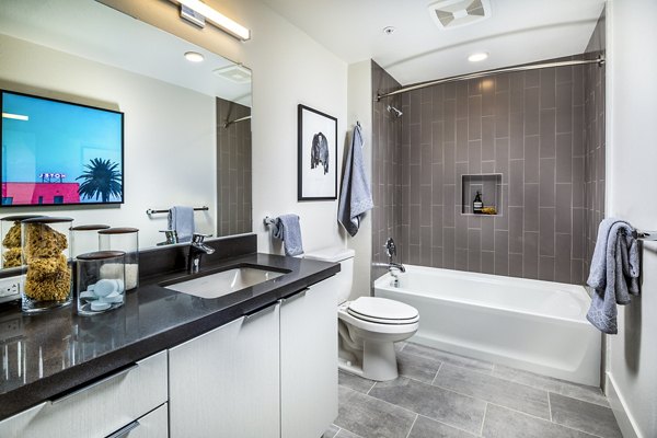 Bathroom with sleek fixtures and modern design at Llewellyn Apartments, a luxury living community by Greystar