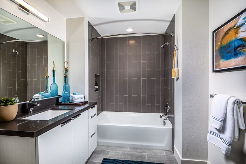 Bathroom with modern fixtures and elegant tiling at Llewellyn Apartments, offering luxury amenities and sophisticated design