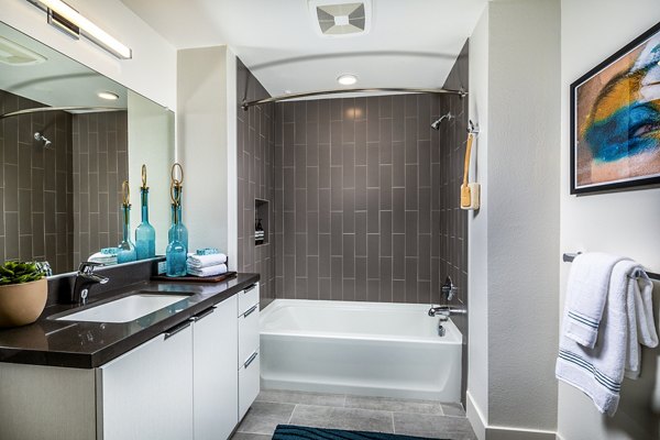 Bathroom with modern fixtures and elegant tiling at Llewellyn Apartments, offering luxury amenities and sophisticated design