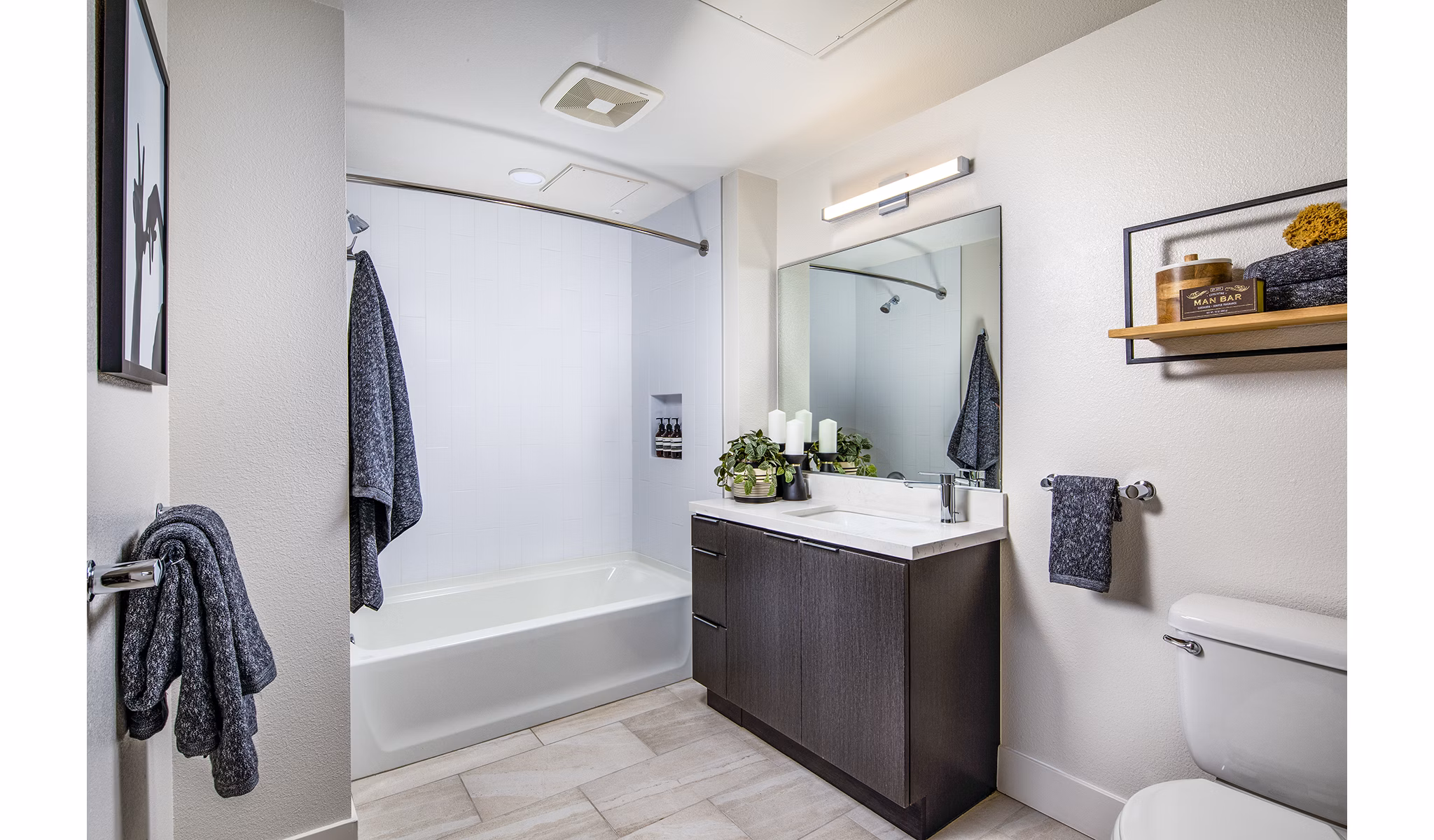 Modern bathroom featuring sleek fixtures and ample lighting at Llewellyn Apartments