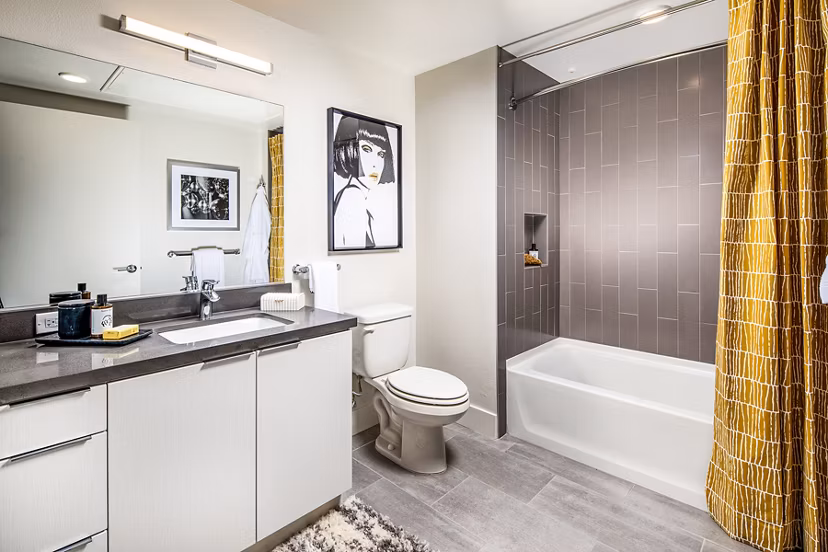 Bathroom with modern fixtures and ample lighting at Llewellyn Apartments
