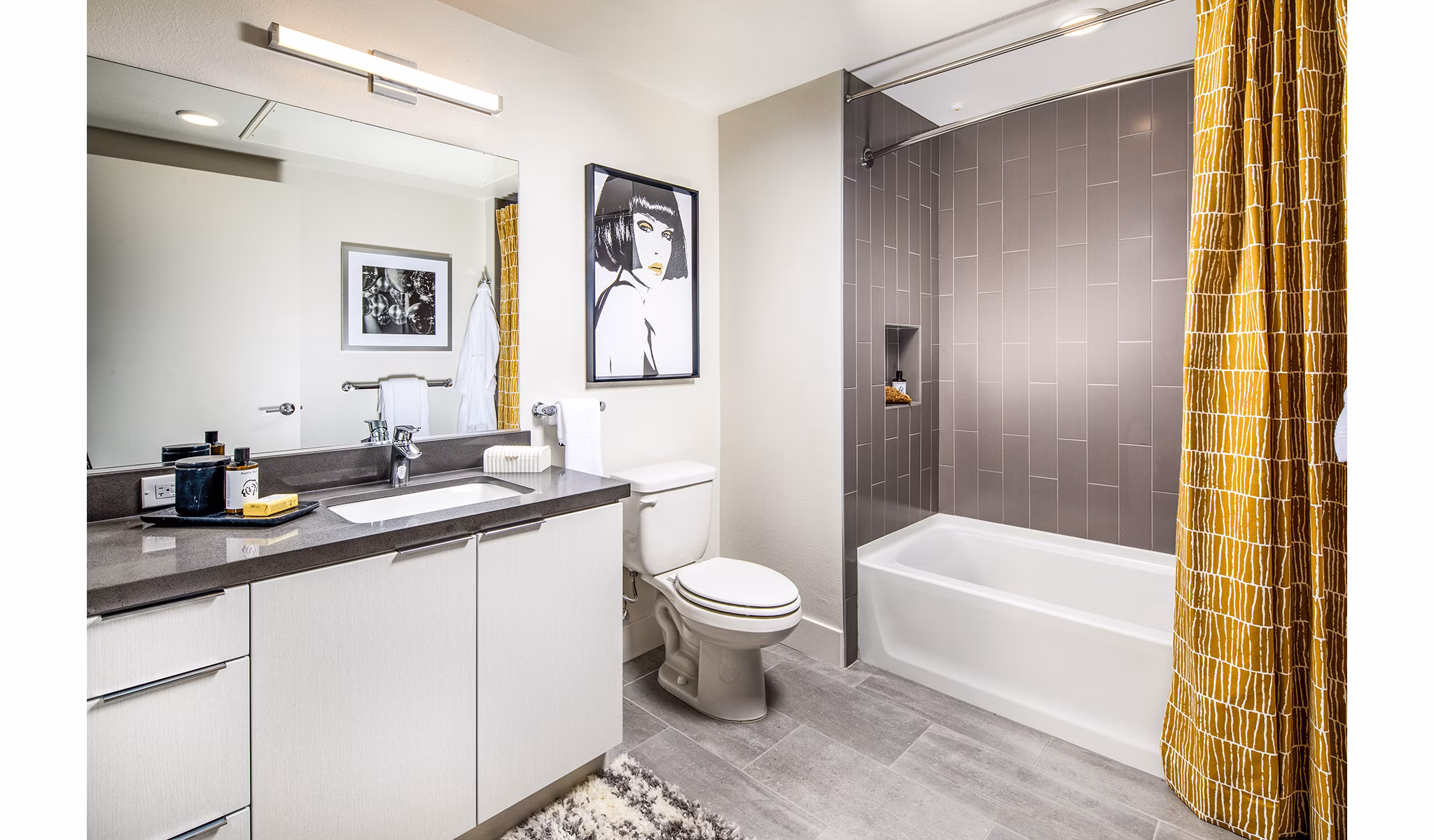 Bathroom with modern fixtures and ample lighting at Llewellyn Apartments