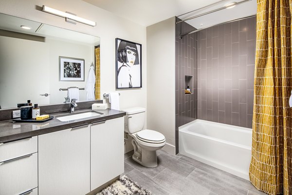 Bathroom with modern fixtures and ample lighting at Llewellyn Apartments