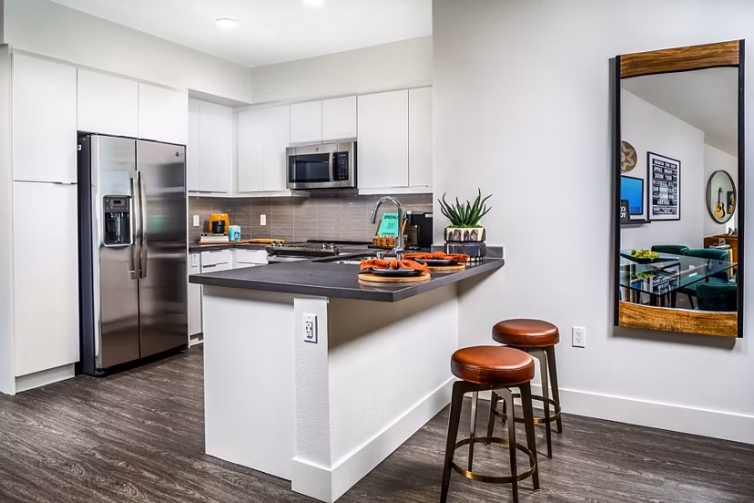 Modern kitchen with stainless steel appliances and island in Llewellyn Apartments