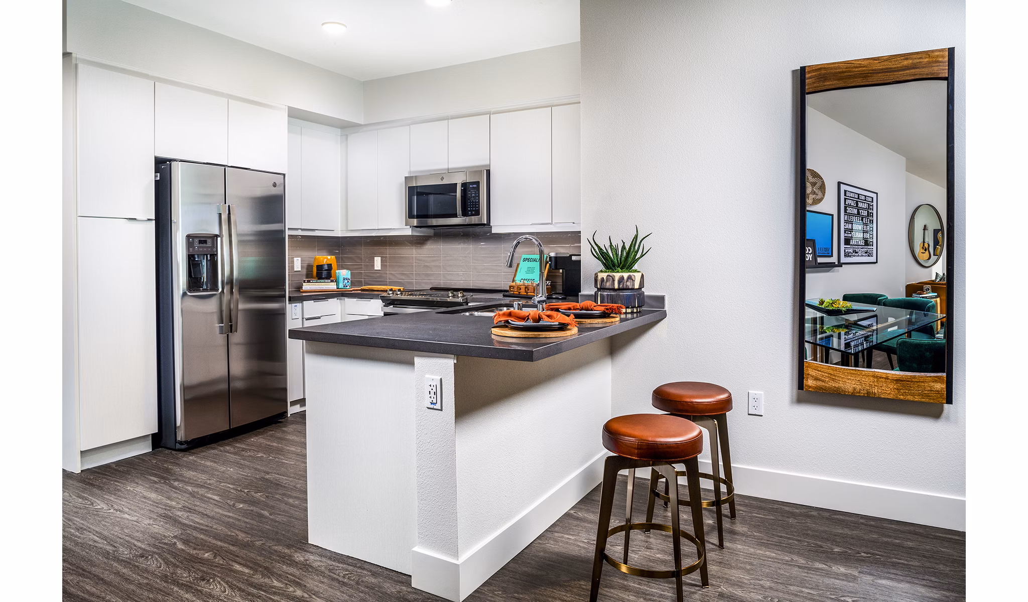 Modern kitchen with stainless steel appliances and island in Llewellyn Apartments