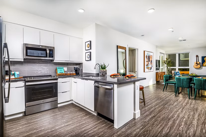 Modern kitchen with stainless steel appliances at Llewellyn Apartments