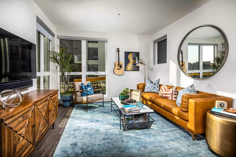 Modern living room with contemporary decor and large windows in Llewellyn Apartments, a Greystar luxury property