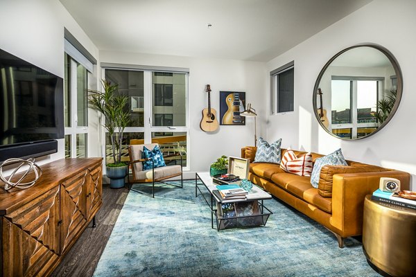 Modern living room with contemporary decor and large windows in Llewellyn Apartments, a Greystar luxury property