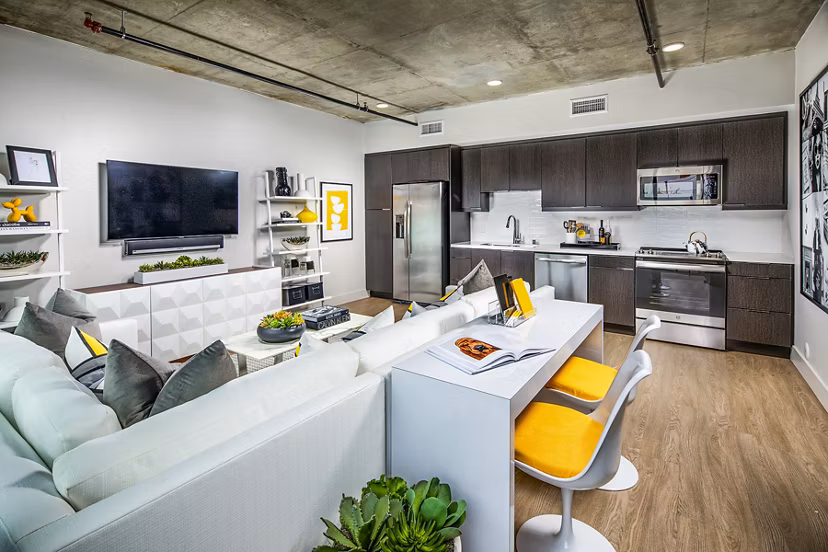 Spacious living room with modern design and large windows at Llewellyn Apartments