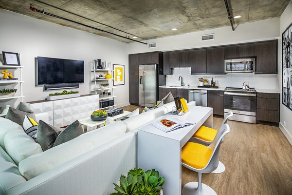 Spacious living room with modern design and large windows at Llewellyn Apartments