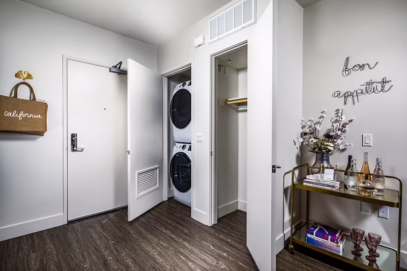 Laundry room with high-efficiency machines at Llewellyn Apartments offering convenience in luxury living