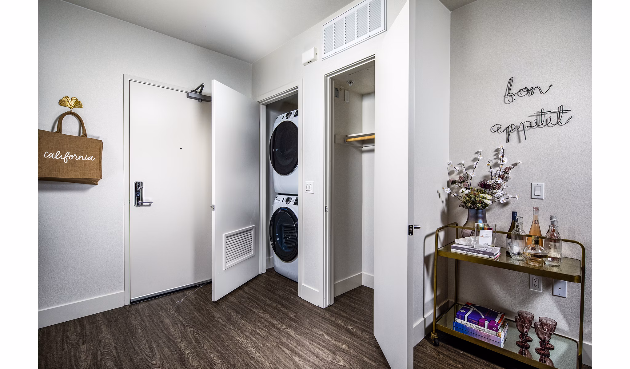 Laundry room with high-efficiency machines at Llewellyn Apartments offering convenience in luxury living