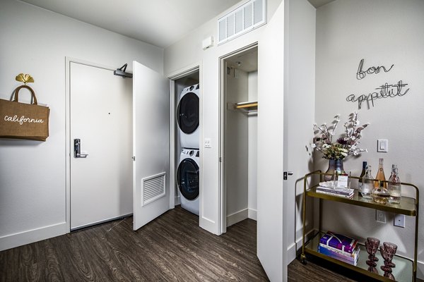 Laundry room with high-efficiency machines at Llewellyn Apartments offering convenience in luxury living