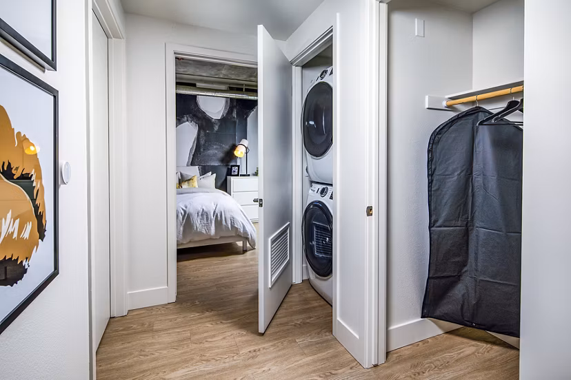 Laundry room with high-efficiency washers and dryers at Llewellyn Apartments offering convenience for residents