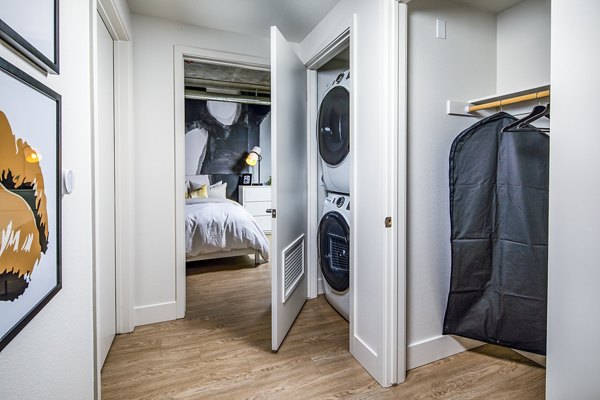Laundry room with high-efficiency washers and dryers at Llewellyn Apartments offering convenience for residents