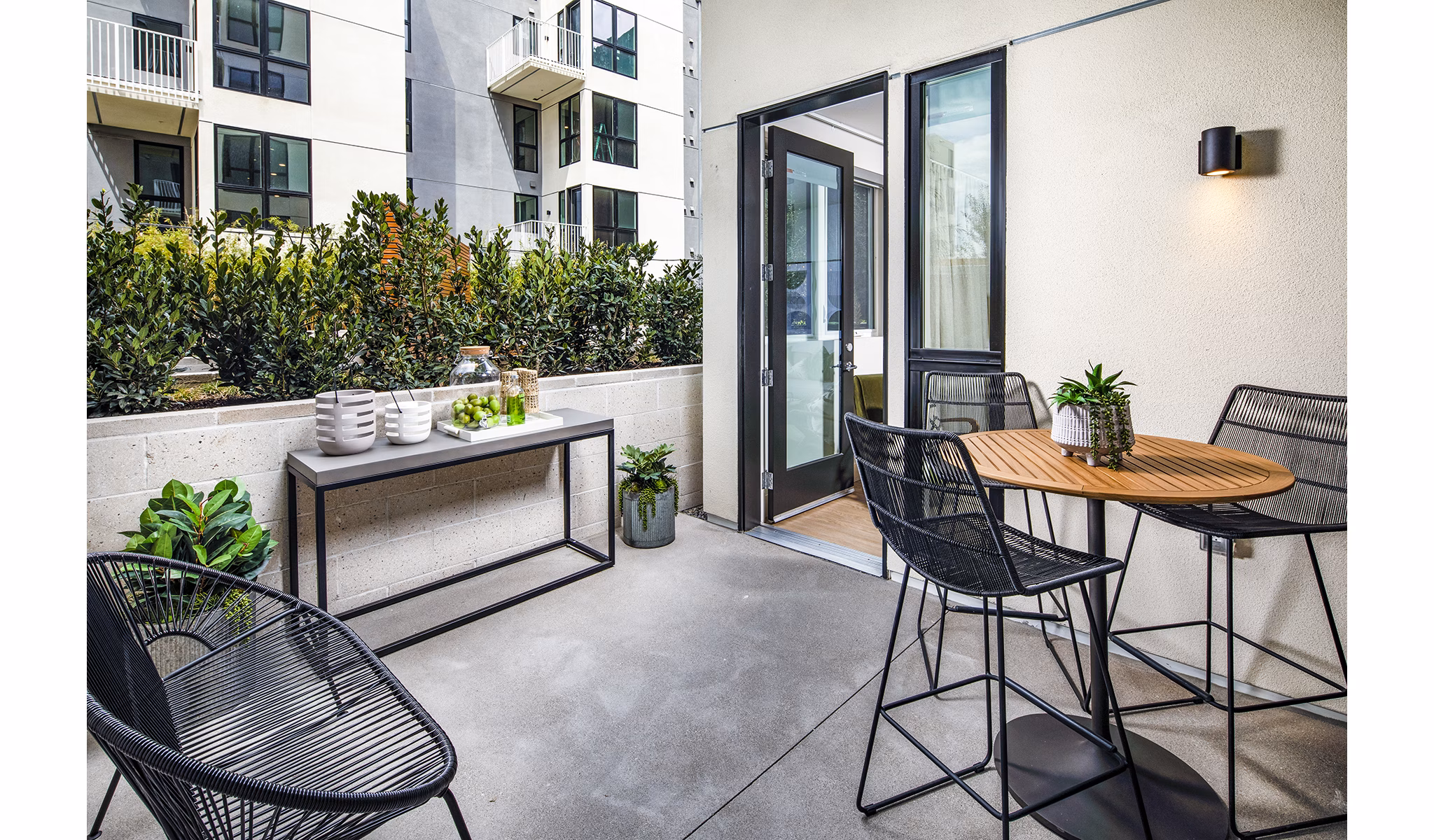 Private patio with seating at Llewellyn Apartments, offering luxurious outdoor living in a tranquil setting
