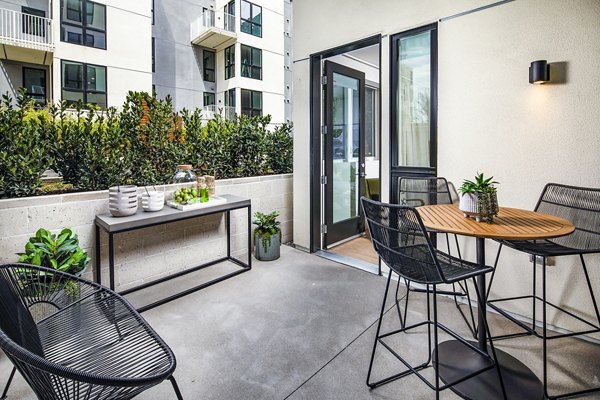 Private patio with seating at Llewellyn Apartments, offering luxurious outdoor living in a tranquil setting
