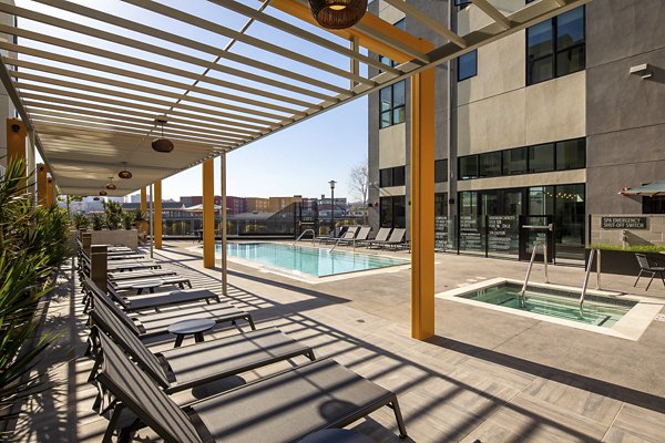 Resort-style pool at Llewellyn Apartments featuring relaxing lounge areas