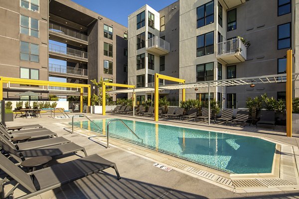 Relaxing pool area with lounge chairs at Llewellyn Apartments, luxury living by Greystar