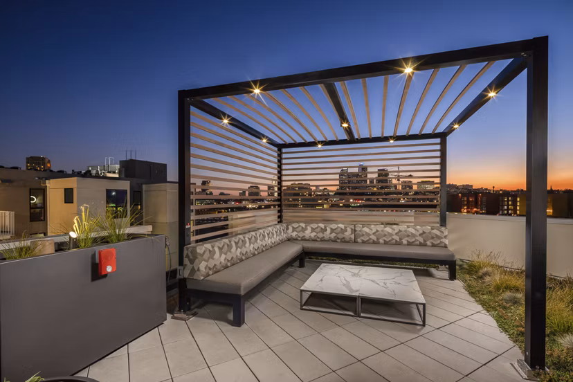 Scenic rooftop deck with seating and greenery at Llewellyn Apartments, offering relaxation and views in a luxurious setting