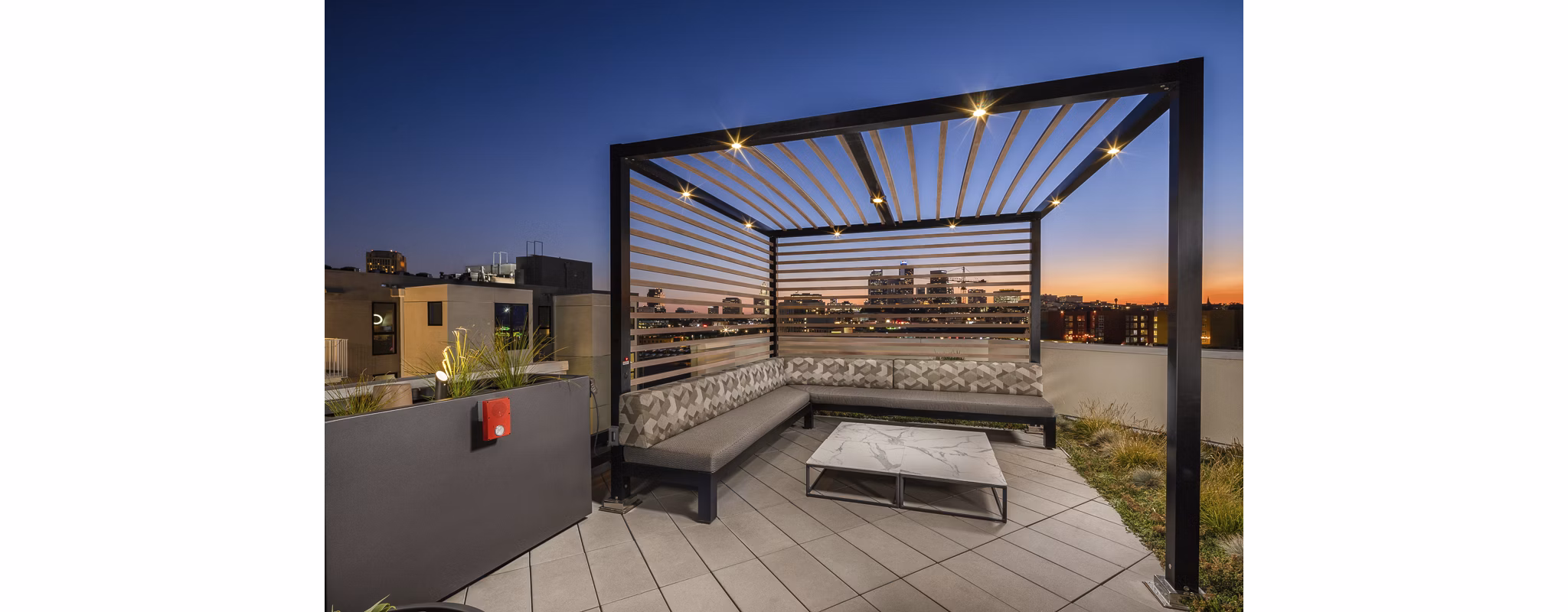 Scenic rooftop deck with seating and greenery at Llewellyn Apartments, offering relaxation and views in a luxurious setting