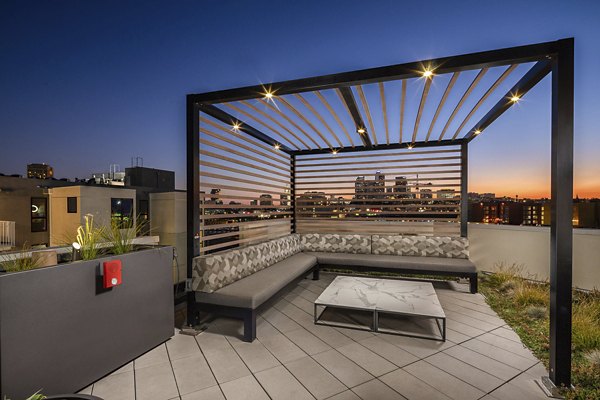 Scenic rooftop deck with seating and greenery at Llewellyn Apartments, offering relaxation and views in a luxurious setting