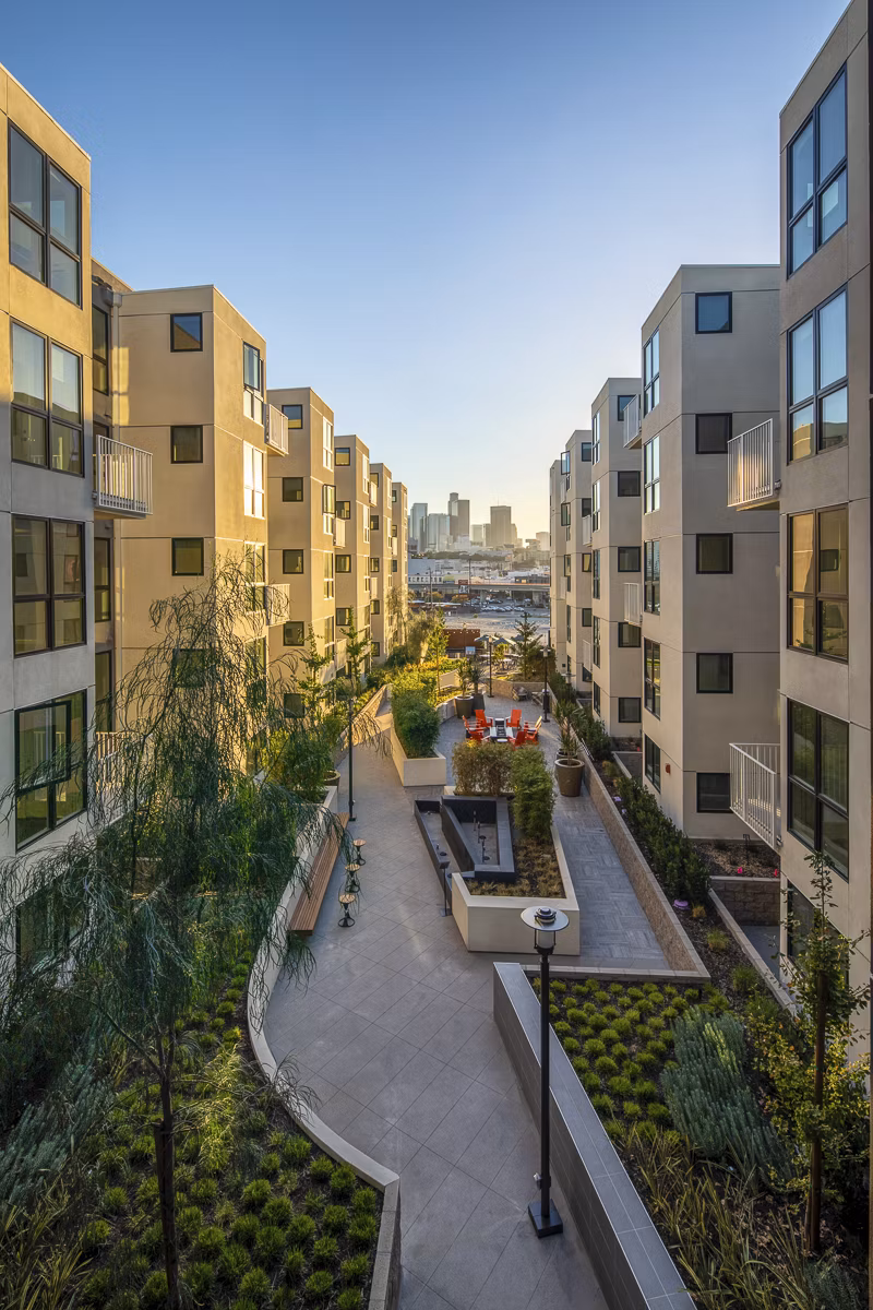 Llewellyn Apartments: Sunset view of luxury high-rise apartments in vibrant downtown setting