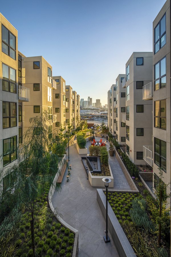 Llewellyn Apartments: Sunset view of luxury high-rise apartments in vibrant downtown setting
