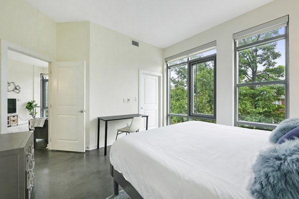 Cozy bedroom in DelRay Tower Apartments with modern furnishings and ample natural light
