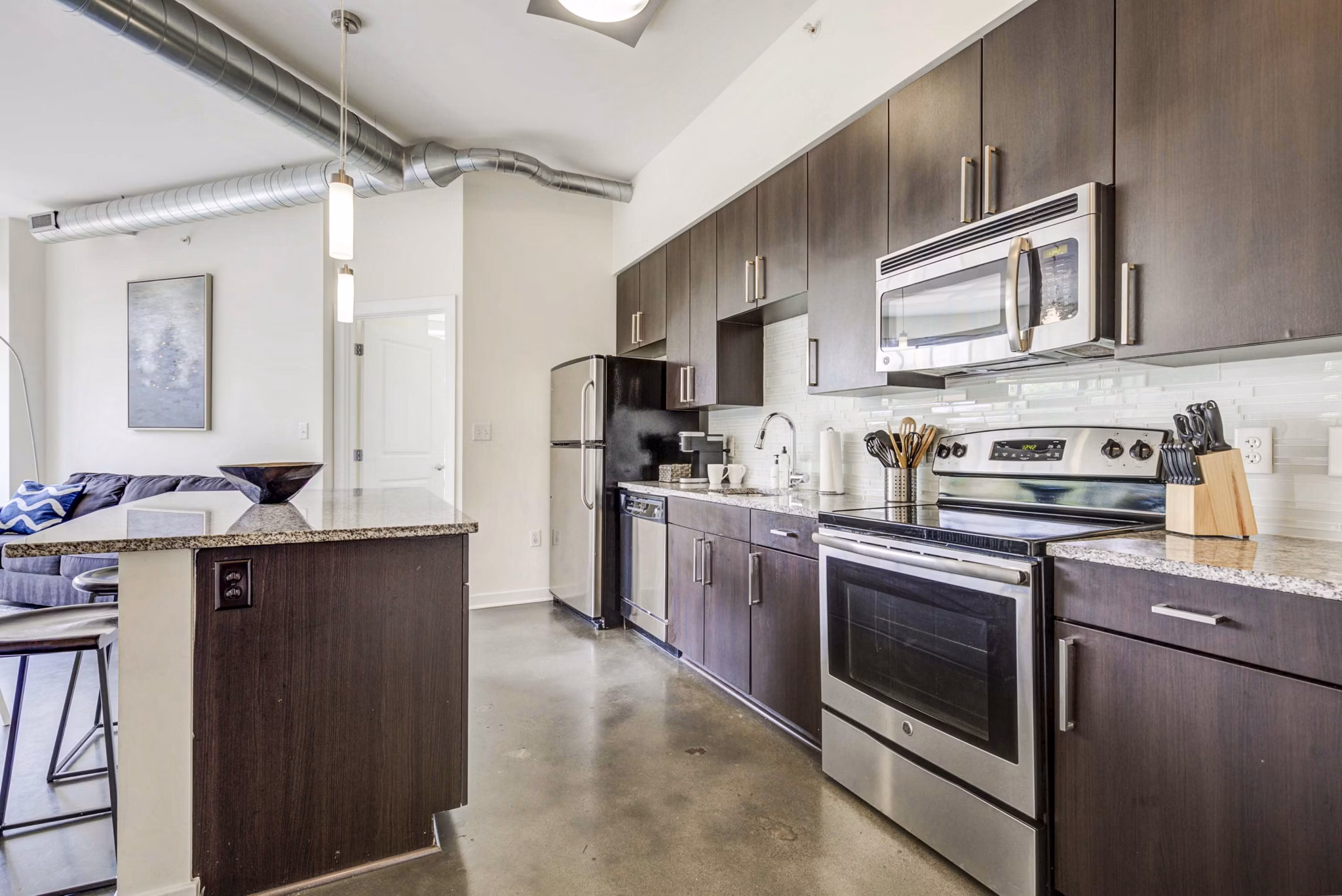 Modern kitchen with stainless steel appliances at DelRay Tower Apartments