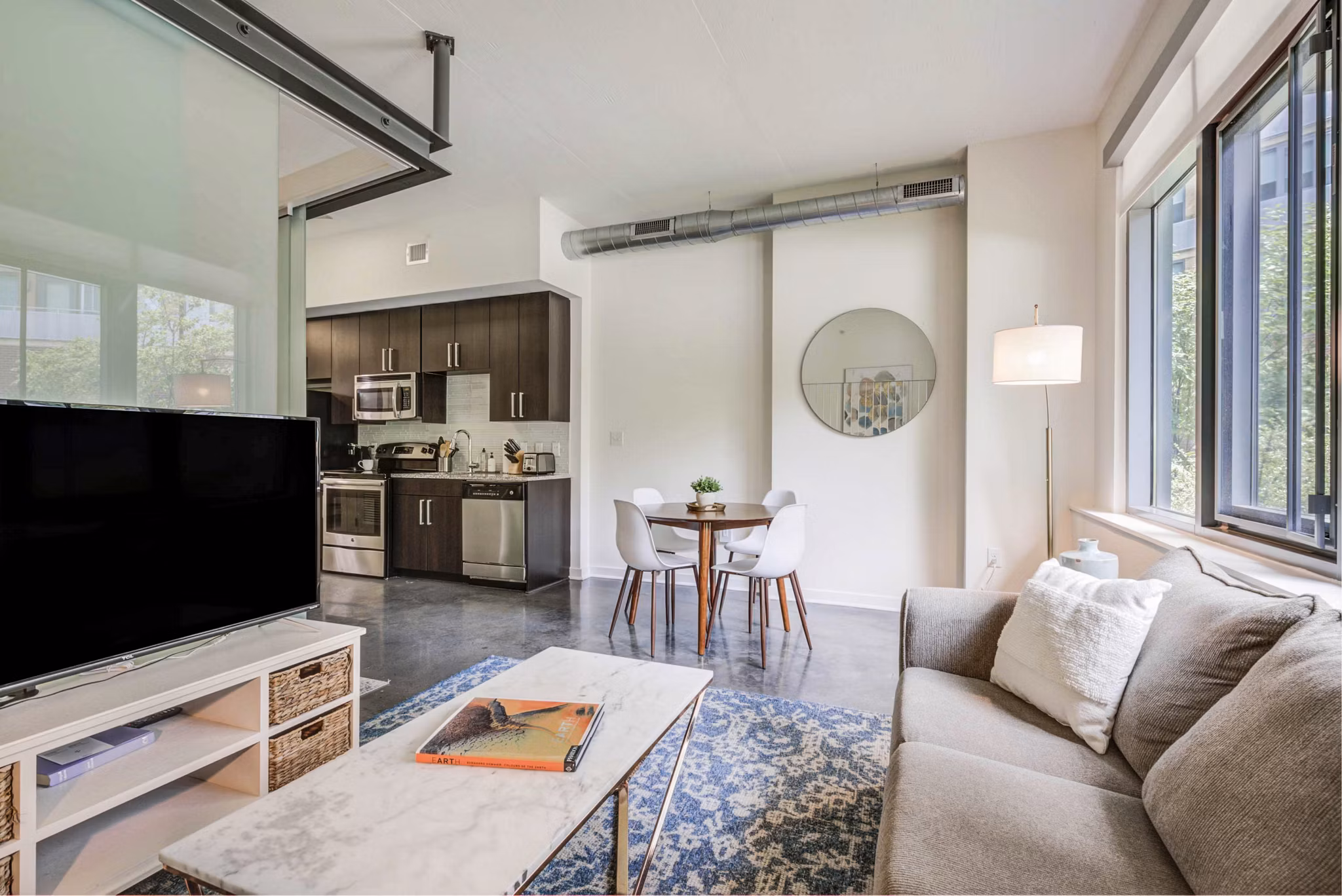 Spacious living room with modern decor and natural light at DelRay Tower Apartments