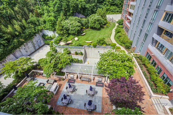 Scenic patio with lounge seating and garden view at DelRay Tower Apartments, luxury living in a peaceful community setting