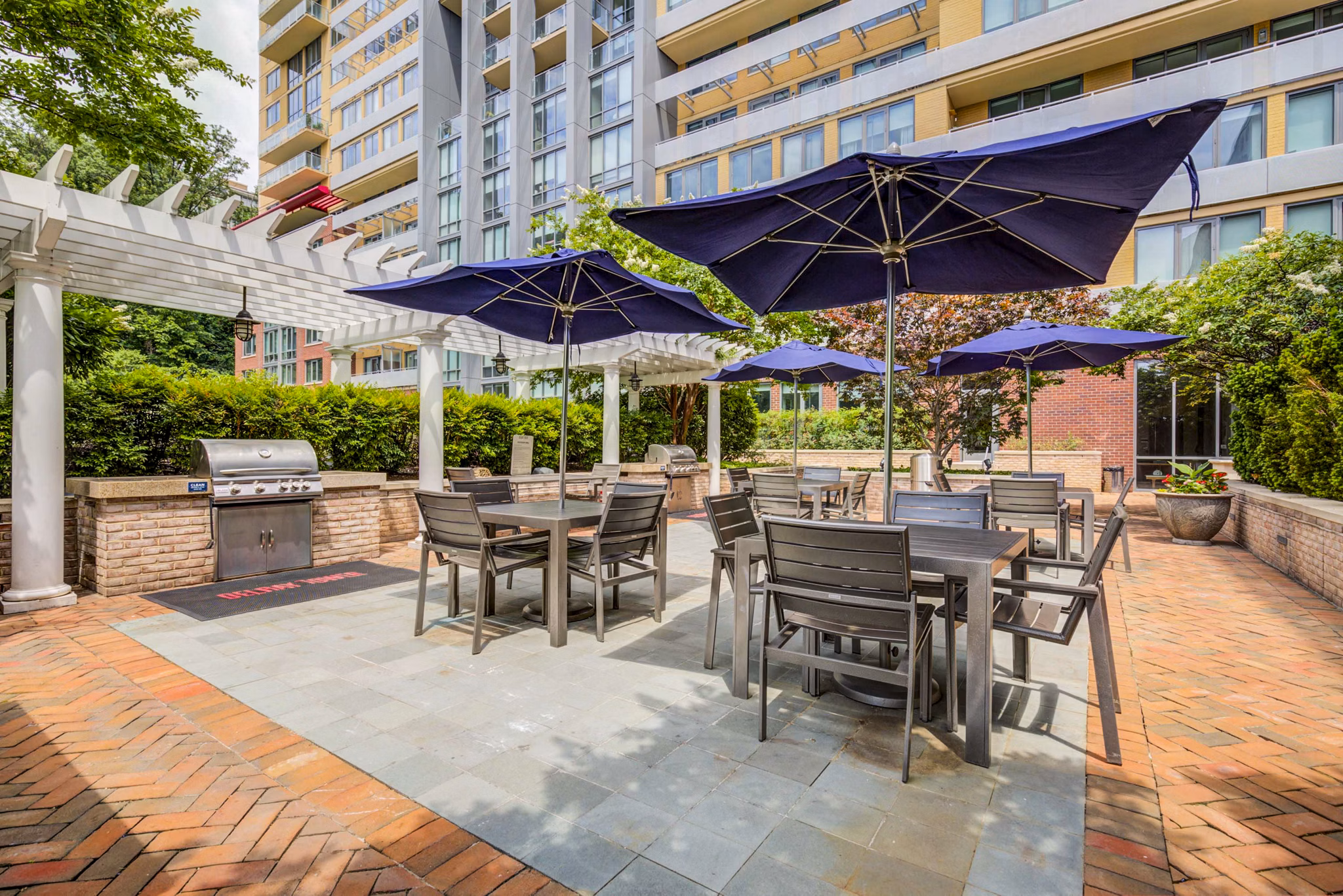 Spacious grill area on the patio at DelRay Tower Apartments, perfect for outdoor gatherings and leisure activities