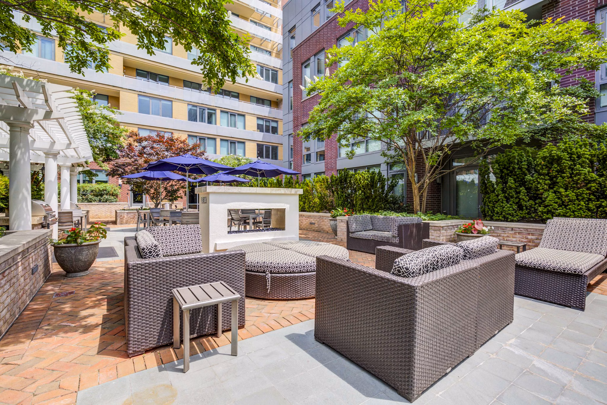 Fire pit lounge at DelRay Tower Apartments offering cozy outdoor seating with modern design elements