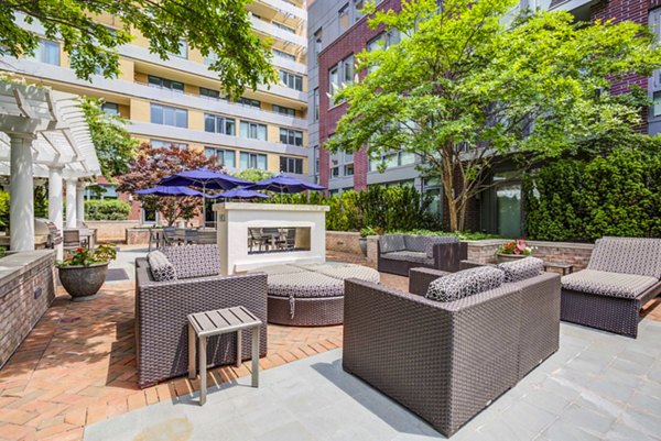 Fire pit lounge at DelRay Tower Apartments offering cozy outdoor seating with modern design elements